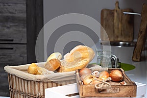 Muffin lies in the kitchen in a small basket, loaves, bread and rolls. Bad food, fullness, copy space