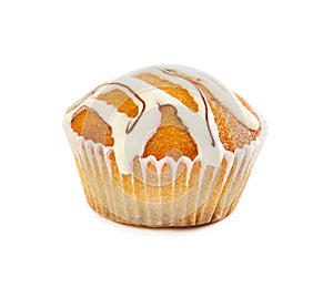 Muffin poured with white liquid chocolate syrup