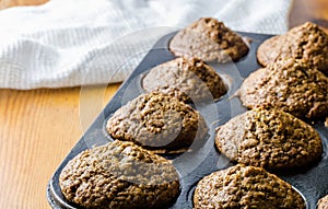 Muffins in baking tray out of oven with copy space