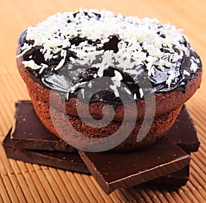 Muffins with desiccated coconut on pieces of chocolate