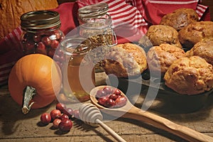 Muffins with fresh cranberries on table