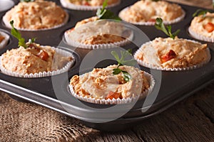 Muffins with ham and cheese in baking dish close up. horizontal