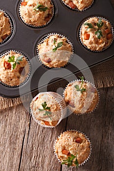 Muffins with ham and cheese in baking dish closeup. vertical top