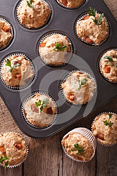 Muffins with ham and cheese close up in baking dish. vertical to