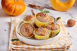 Muffins with pumpkin, walnuts and cinnamon. Delicious homemade dessert.