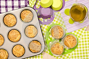Muffins in a tray and on colorful napkin.