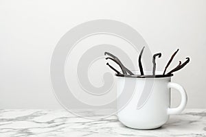 Mug with aromatic vanilla sticks