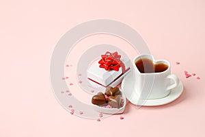 Mug with balck coffee, chocolate hearts, gift box on pink background. Flat lay composition. Romantic, St Valentines Day concept,