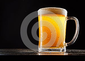 Mug of beer against black background