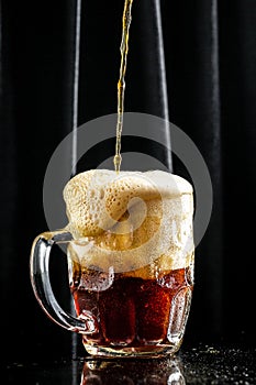 Mug of beer on dark background, glass with thick foam, vertical image. place for text
