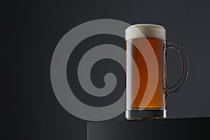 Mug of beer on dark grey background