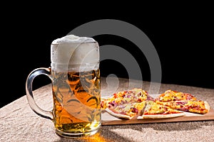Mug of Beer and Slices of Pizza on Cutting Board