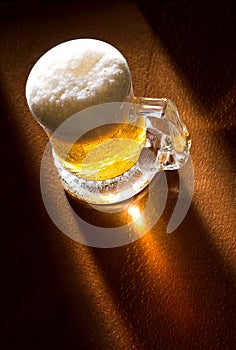 Mug of beer on wooden table