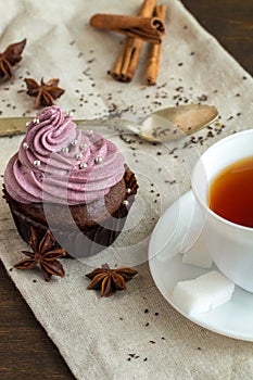 Mug of blacktea with chocolate cupcakes