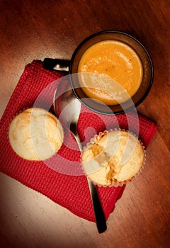 Mug of butternut bisque and corn muffins