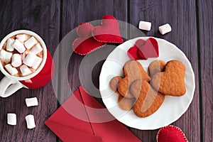 Mug of chocolate with heart gingerbread cookies