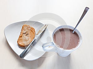 Mug with chocolatte and toast with peanut butter