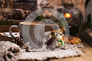 Mug of cocoa with chocolate chip cookies on a wooden table. Christmas drink and biscuit, festive decoration with