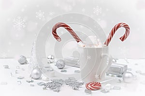 Mug of cocoa, hot chocolate with marshmallows and red lollipops on a white background, snowflakes, silver balls, transparent