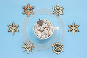 Mug cocoa marshmallows and large wooden snowflakes