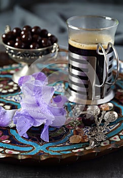 Mug of coffee, chocolate drops and iris flower