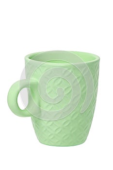 Mug of coffee. Closeup of a green ceramic mug or tea cup isolated on a white background. Macro