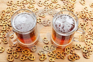 Mug of cold foamy beer with german brezel. Overhead view