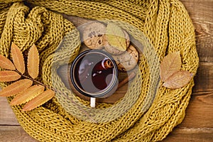 Mug or Cup of Hot Berry Tea With Yellow Warm Knitted Scarf Autumn Maple Leaves Wooden Background Top View Flat Lay Autumn Cold sea