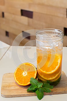 Mug delicious refreshing drink of orange fruit , infused water