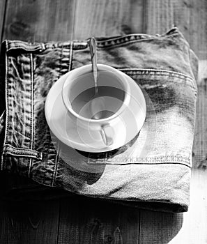 Mug filled boiling water and tea bag on blue jeans background. Process tea brewing in ceramic mug. Herbal green or black