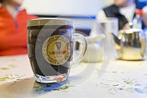 Mug filled with Guinness beer photo