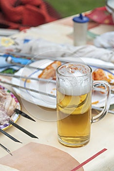 Mug of foamy beer on the table