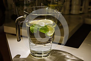 A mug of fresh water with lemon