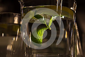 A mug of fresh water with lemon