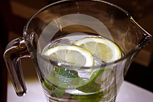 A mug of fresh water with lemon