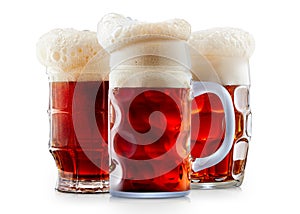 Mug of frosty dark red beer with foam