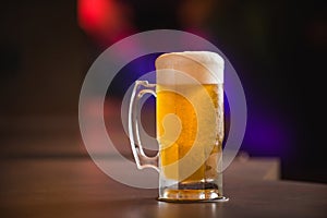 Mug full of chopp, with chopp pilsen on a rustic table.