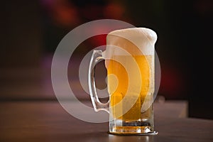 mug full of chopp, with chopp pilsen on a rustic table.