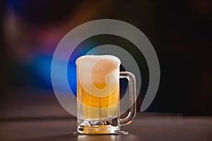 mug full of chopp, with chopp pilsen on a rustic table.