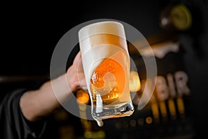 mug full of chopp, with chopp pilsen on a rustic table.