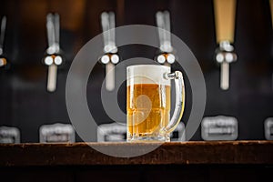 mug full of chopp, with chopp pilsen on a rustic table.