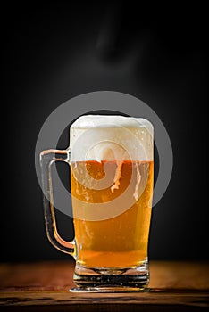 mug full of chopp, with chopp pilsen on a rustic table.