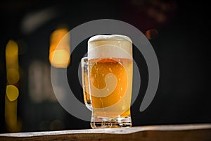mug full of chopp, with chopp pilsen on a rustic table.