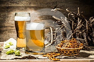 Mug, glass of beer on wooden table