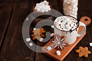Mug of hot chocolate or cocoa with Christmas cookies and marsmallow photo