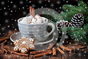 Mug with hot chocolate and gingerbread cookies on wooden table