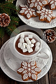 Mug with hot chocolate and gingerbread cookies on wooden table