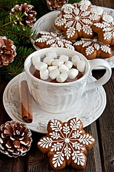 Mug with hot chocolate and gingerbread cookies on wooden table