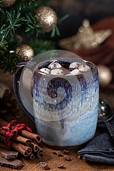 Mug of hot chocolate and marshmallows with Christmas decorations