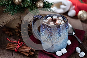 Mug of hot chocolate and marshmallows with Christmas decorations